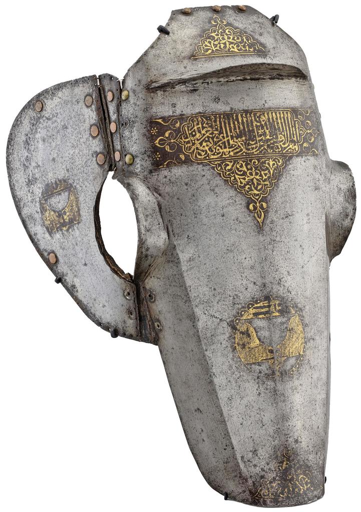 Chanfrein au nom de l’émir Muqbil al-Rumi, Syrie (?), vers 1419. Acier damasquiné d’or, cuir, restes de matelassage de textile et crin, 55,5 x 32,2 x 30 cm. Lyon, musée des Beaux-Arts. 