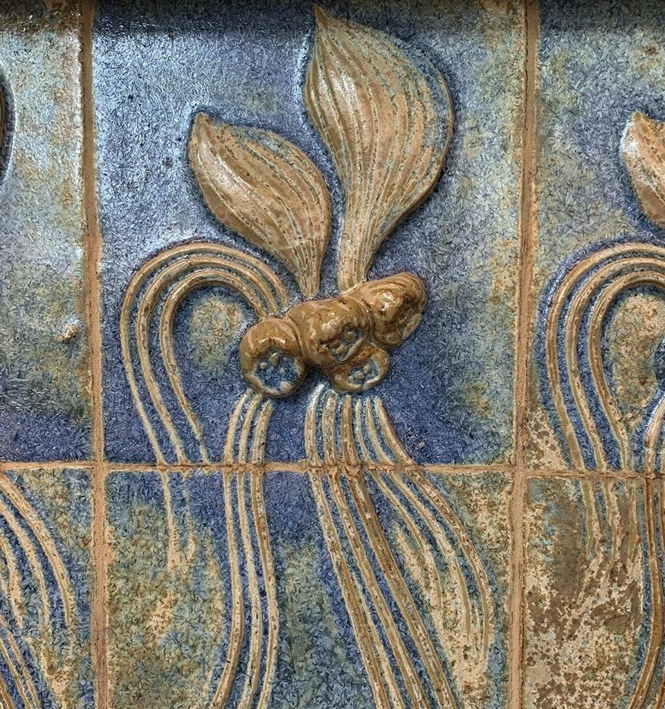 La véranda, qui a retrouvé son aspect d'origine, est ornée d'une frise en grès d'Alexandre Bigot sur le motif des lentilles d'eau.