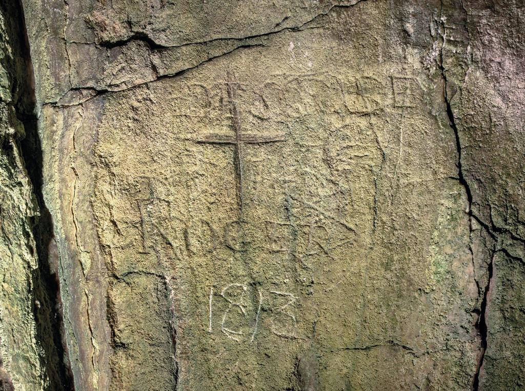 Inscriptions pariétales relevées dans l’une des grottes de l’île‐prison de Cabrera ; deux noms français, une croix et la date 1813.