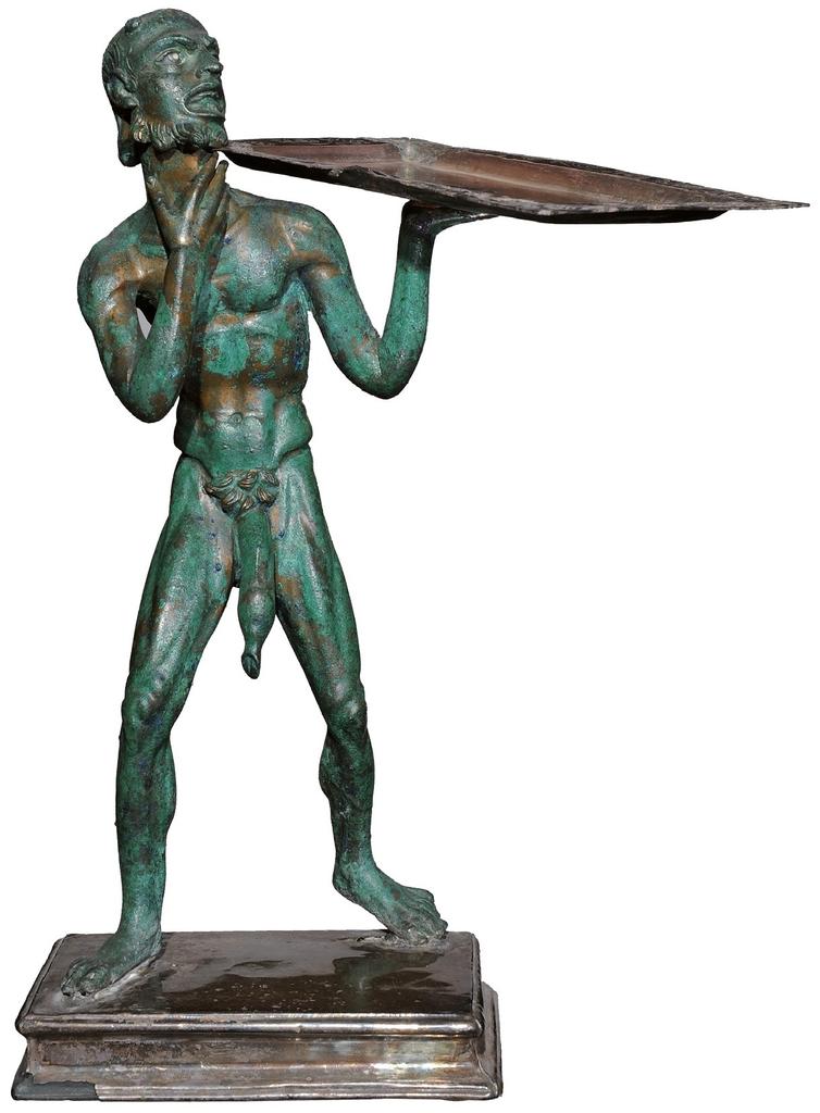 Statuette en bronze représentant un marchand de pain. Pompéi, Maison de l’Éphèbe, Iᵉʳ siècle de notre ère.